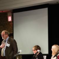 The panelists listen to Kelly Parker share his view on climate change.
